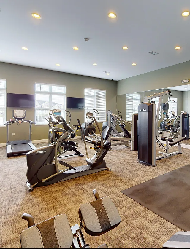 Modern and spacious fitness center equipped with state-of-the-art exercise machines and ample natural light.