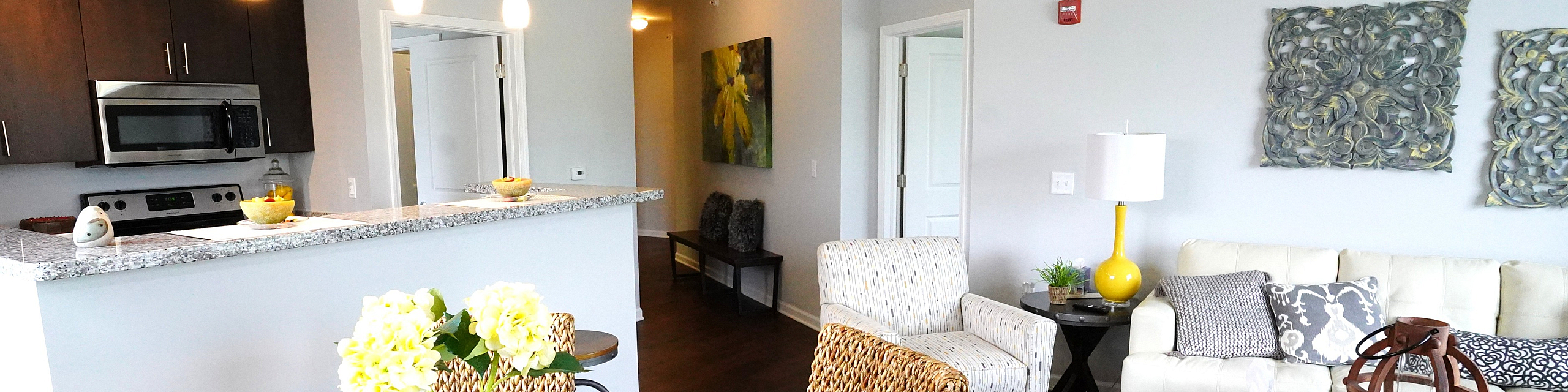 Chic open-floor living with a cozy seating area, stylish dining setup, and modern kitchen with elegant lighting.
