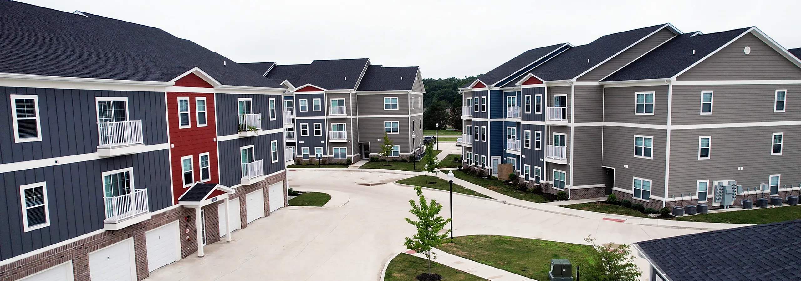Charming apartment complex featuring modern architecture with colorful facades, spacious balconies, and well-maintained green spaces.