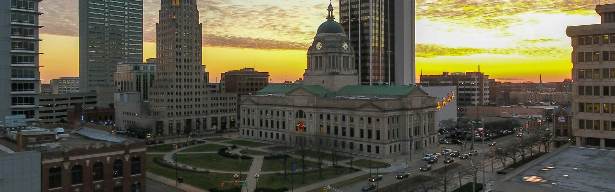 Stunning cityscape view featuring historic architecture and modern high-rises at sunset, offering a vibrant urban atmosphere.