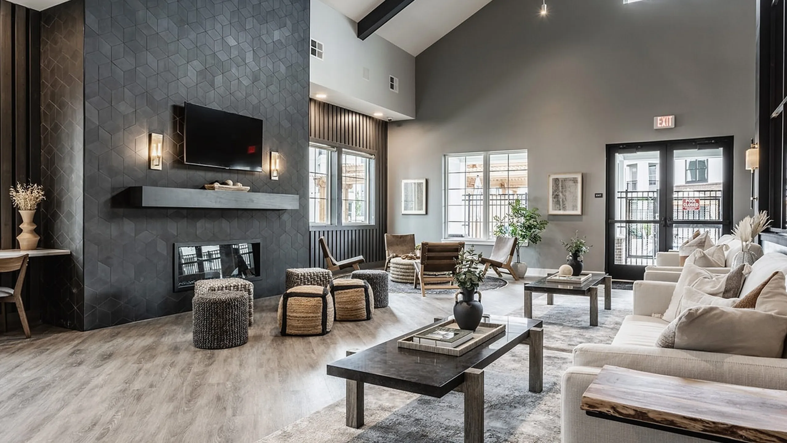 Luxurious room with high ceilings, modern fireplace, and chic furnishings creating a warm and inviting atmosphere.