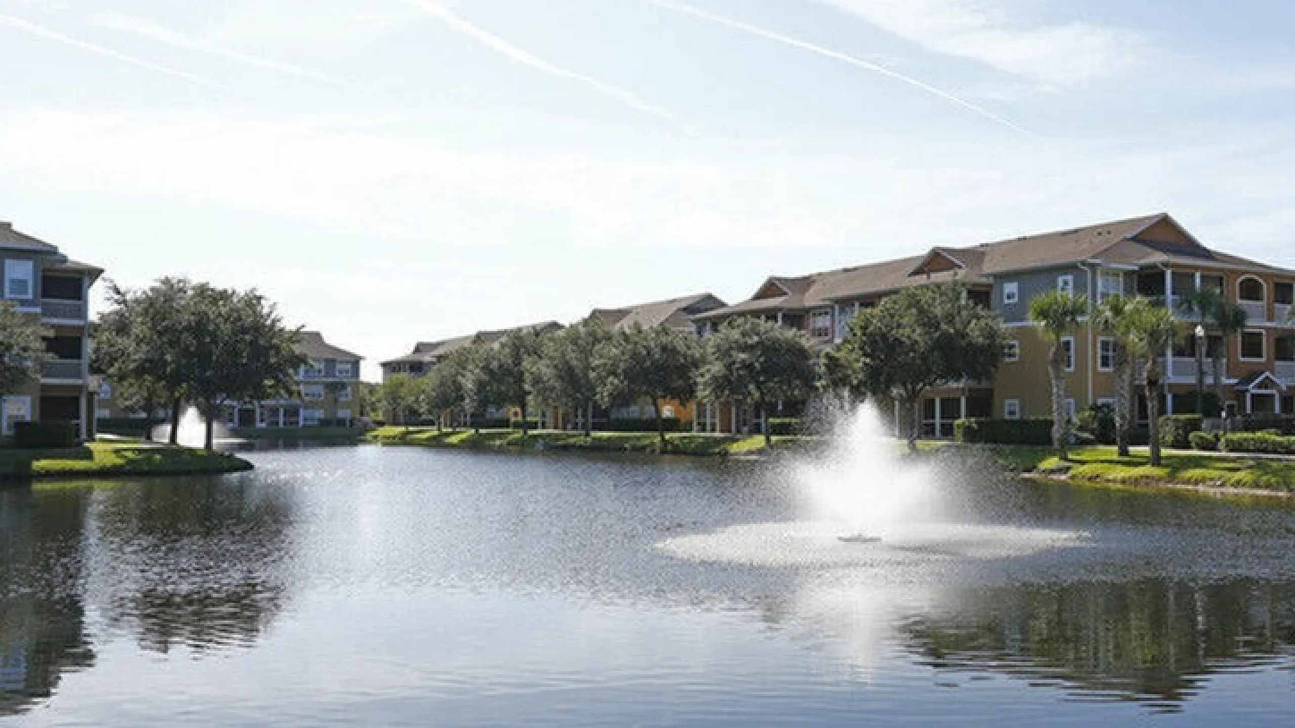 Elegant lakeside apartments with scenic water views and lush landscaping.