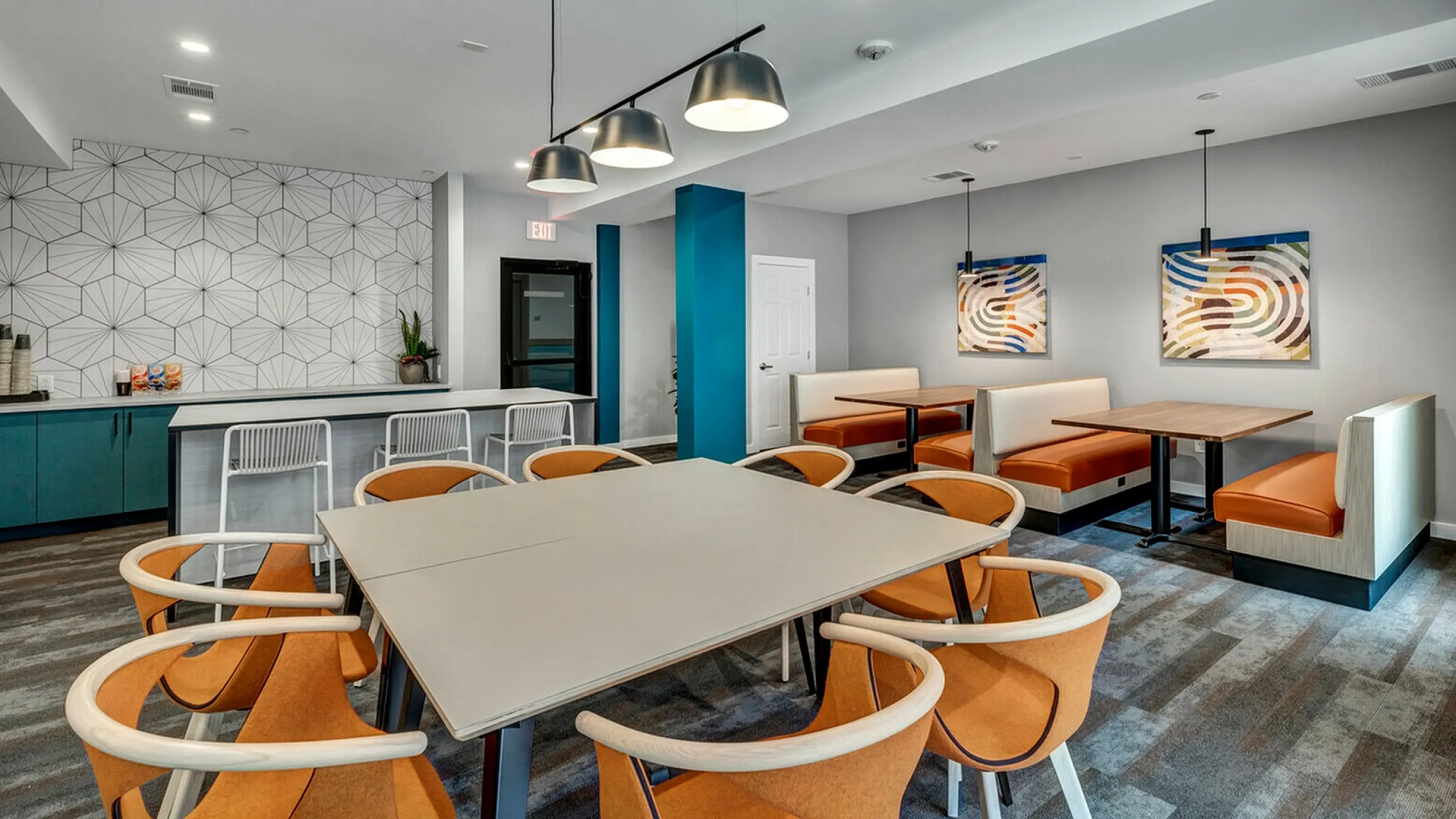 Stylish dining space with modern seating, geometric wall pattern, and ambient lighting.