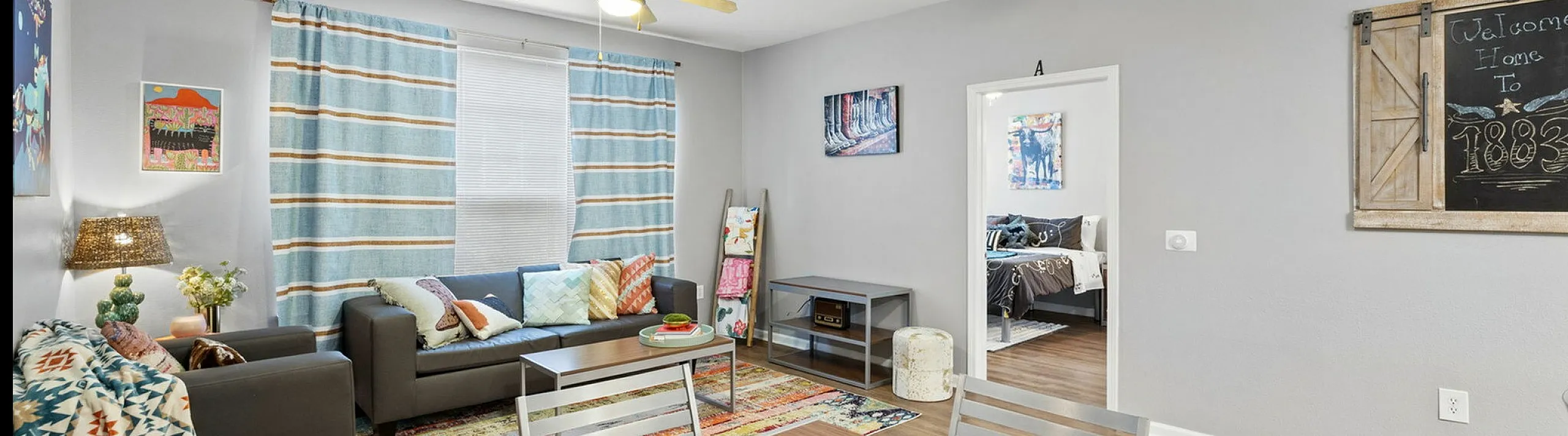 Inviting living space with modern decor, cozy seating, and natural light pouring in through large windows, perfect for relaxation and entertaining.