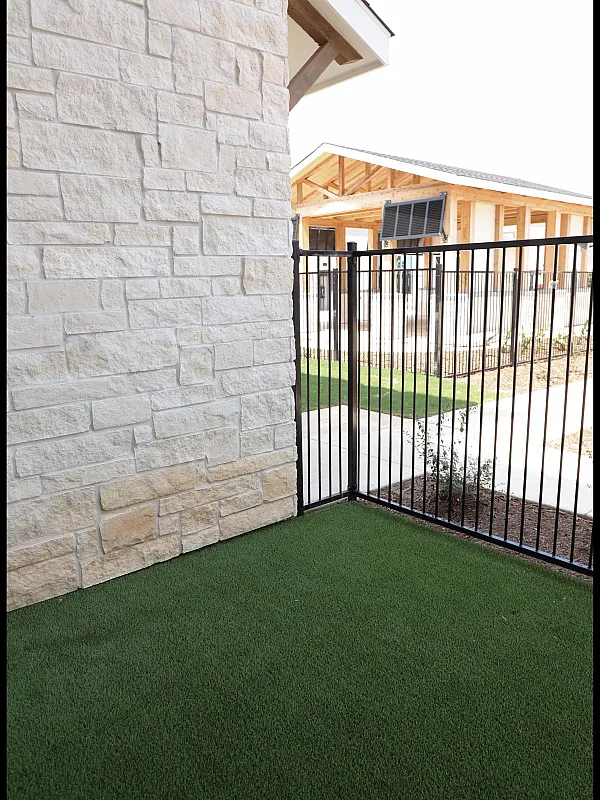 Elegant garage exterior with modern beige paneling and a sleek black wall light for a contemporary appeal.