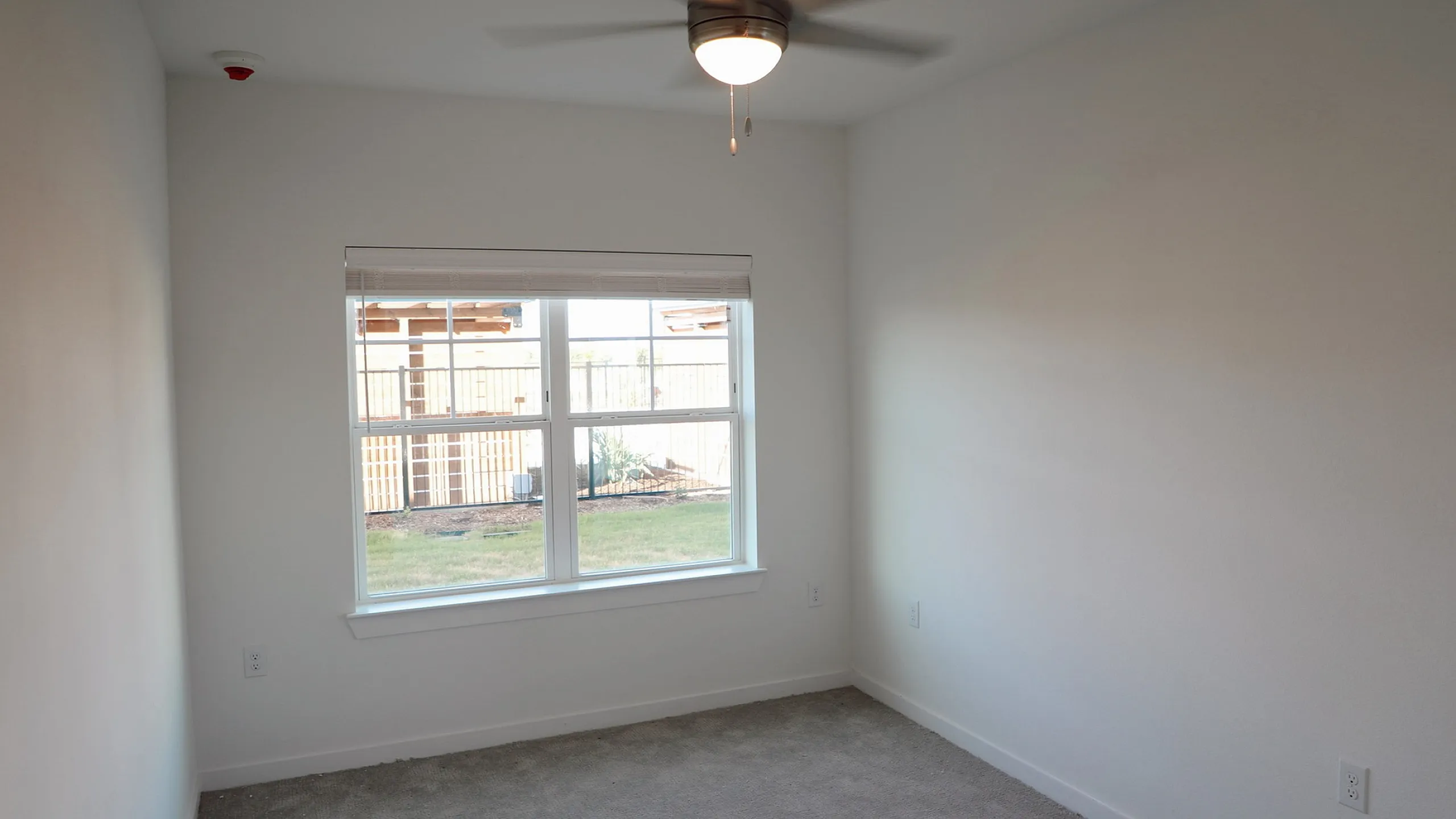 Luxurious apartment complex featuring a sparkling pool with lounge chairs, inflatables, and a vibrant social atmosphere.