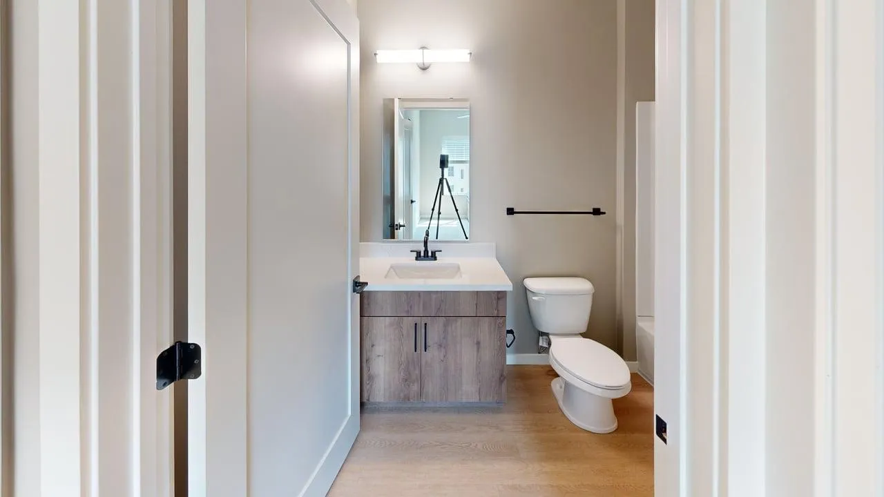 Elegant bathroom with modern fixtures, wood vanity, and natural light, perfect for relaxation.