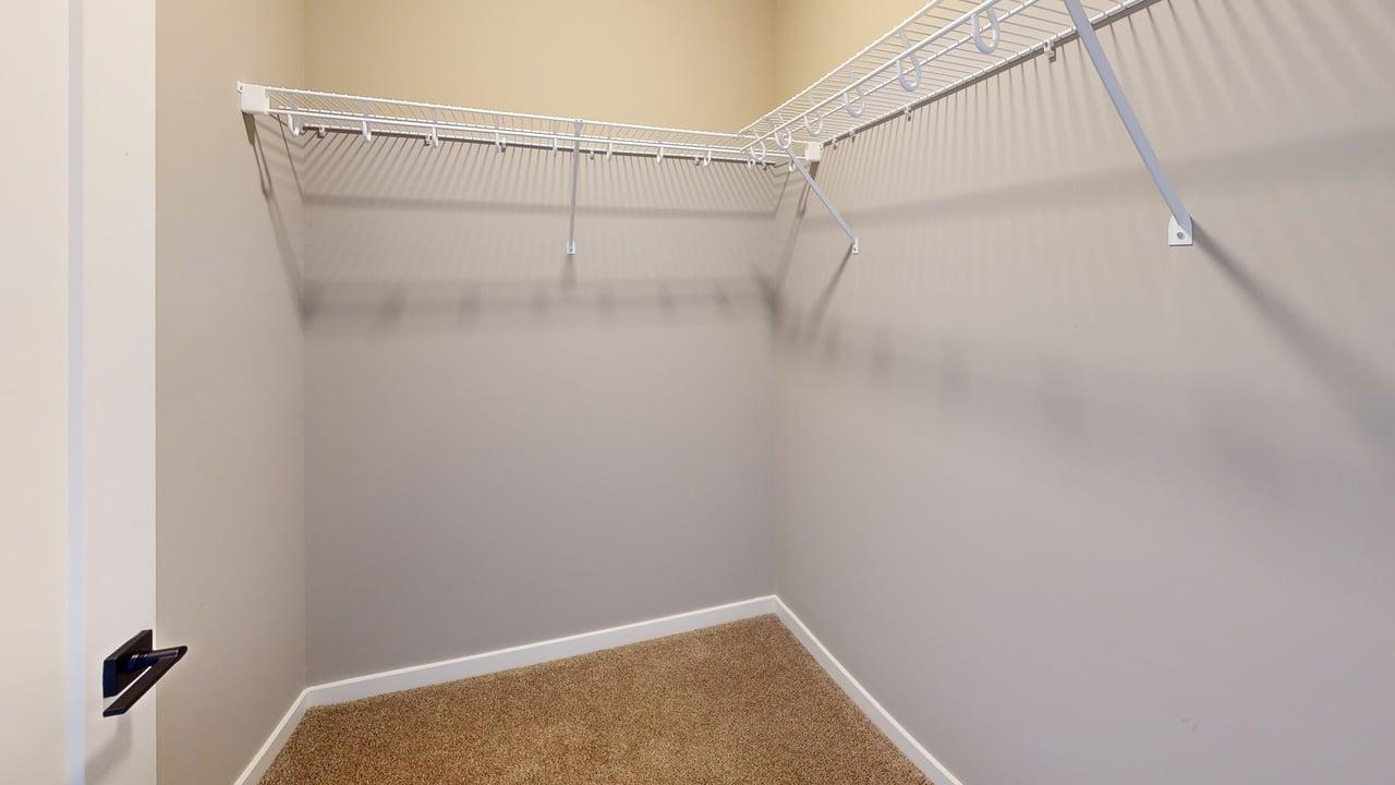Spacious walk-in closet with ample shelving and modern design.