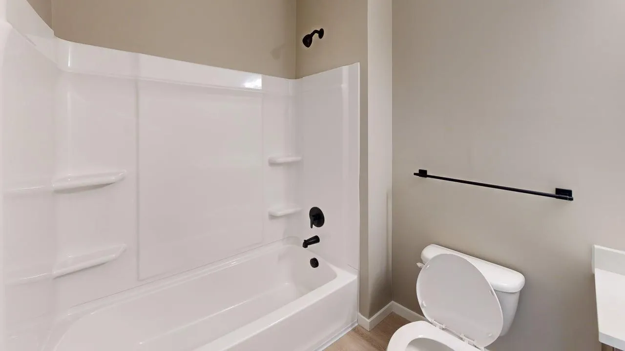 Modern bathroom with sleek white bathtub, stylish fixtures, and contemporary design.