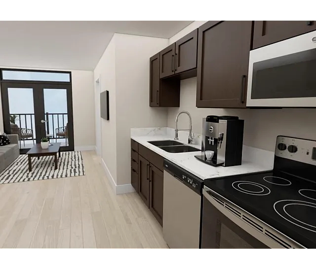 Modern apartment interior showcasing an open-plan living area with sleek kitchen, cozy sitting space, and balcony access.