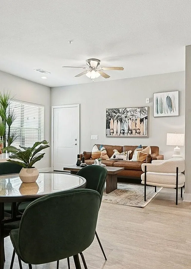 Modern and inviting living space featuring a stylish dining area, elegant furniture, and tasteful decor with ample natural light.