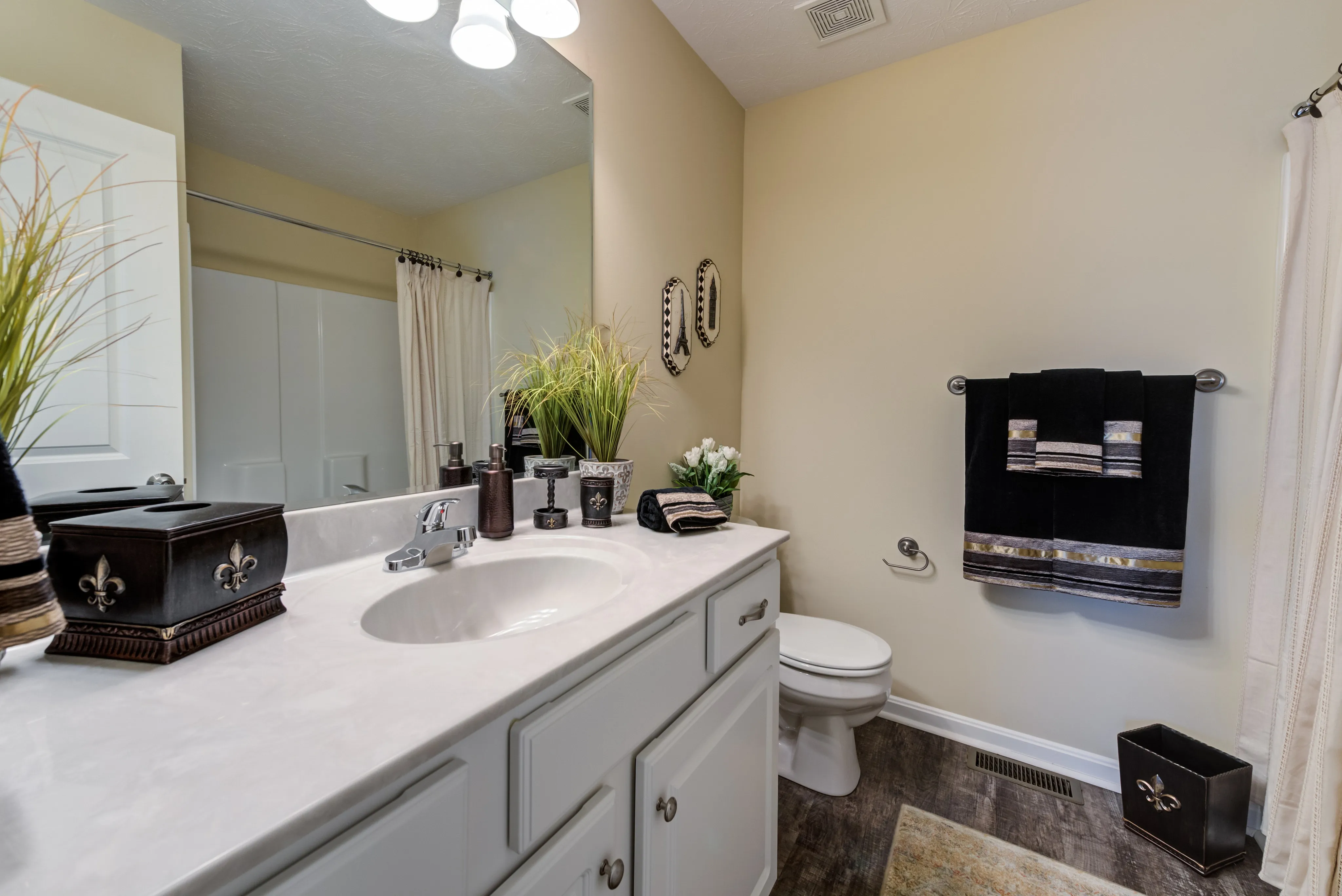 Elegant bathroom with modern fixtures, marble countertop, and decorative accents enhancing a luxurious feel.