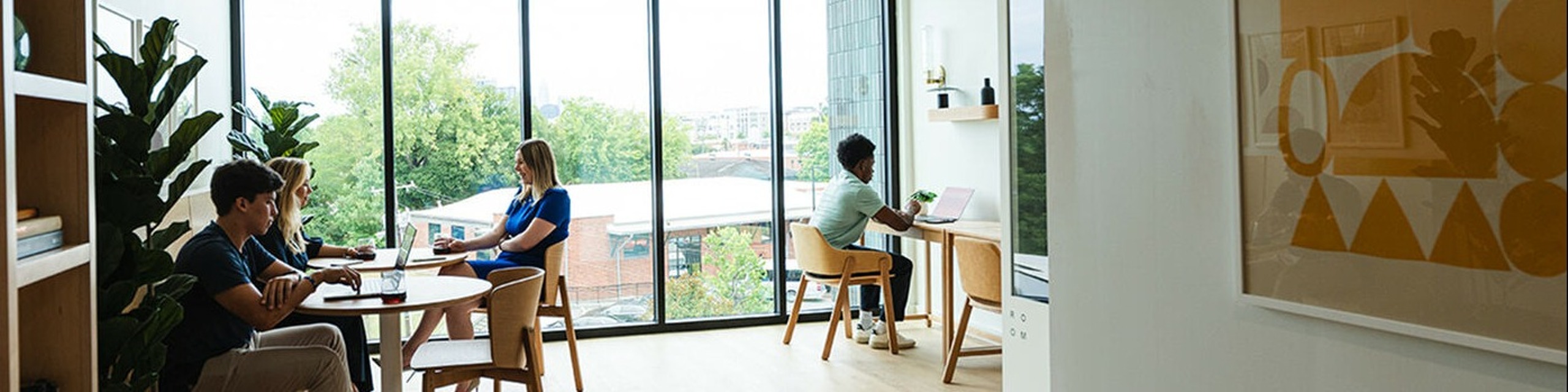 people working in the common space at Foster Flats in South End Charlotte