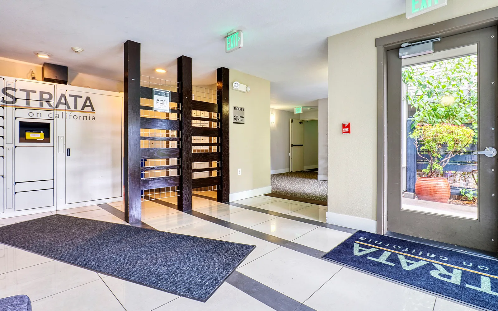 Modern Strata apartment lobby with sleek design, glossy tiled floors, and vibrant natural light in California.