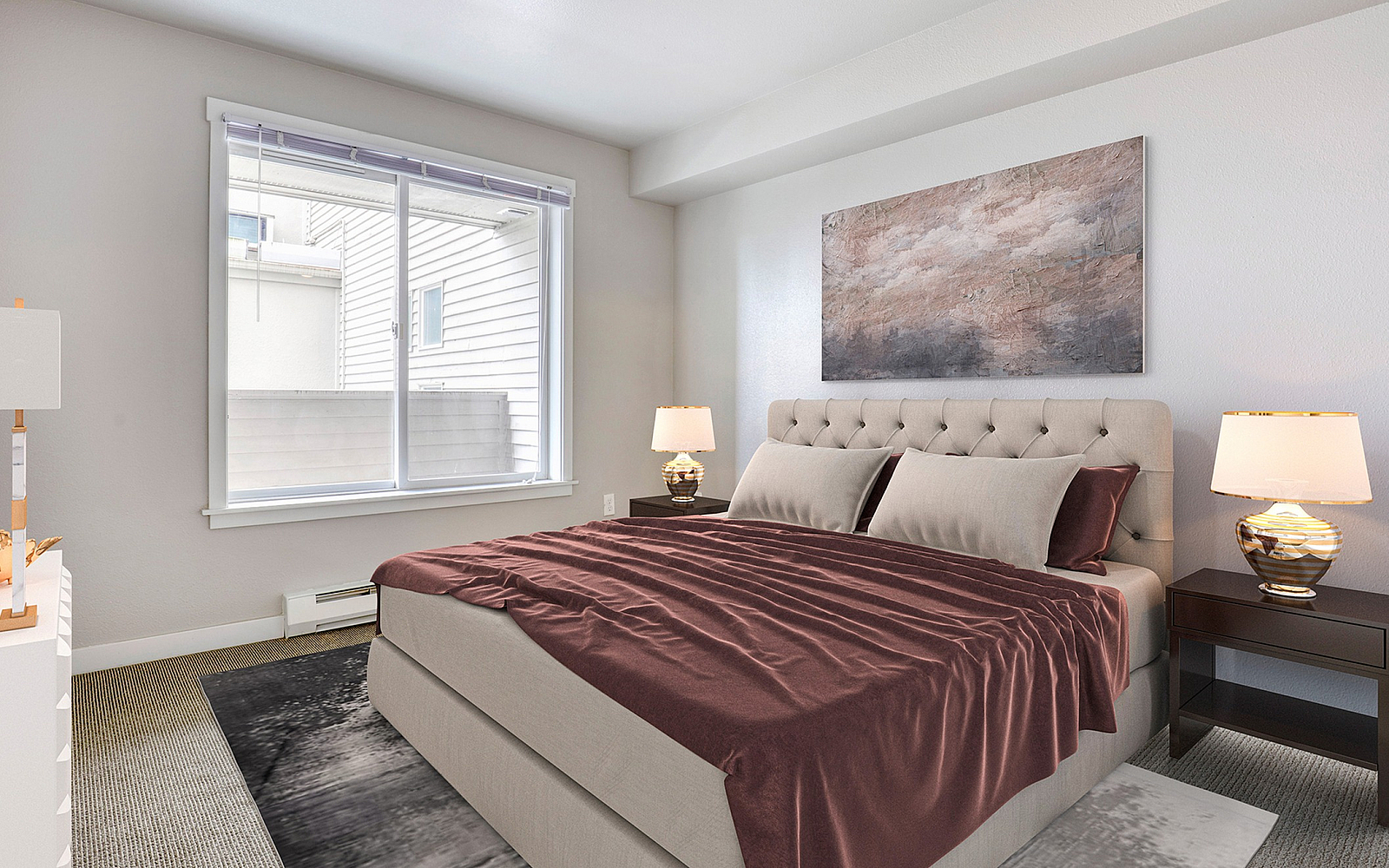 Elegant bedroom featuring a plush king-sized bed with rich maroon bedding, warm lighting, and a serene artwork, offering a tranquil and inviting ambiance.