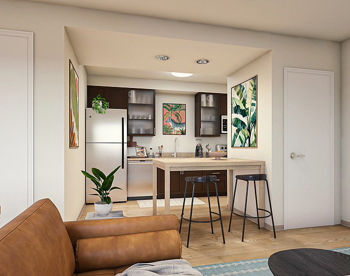 Chic open-plan kitchen with modern decor, featuring a cozy dining area and stylish bar stools.