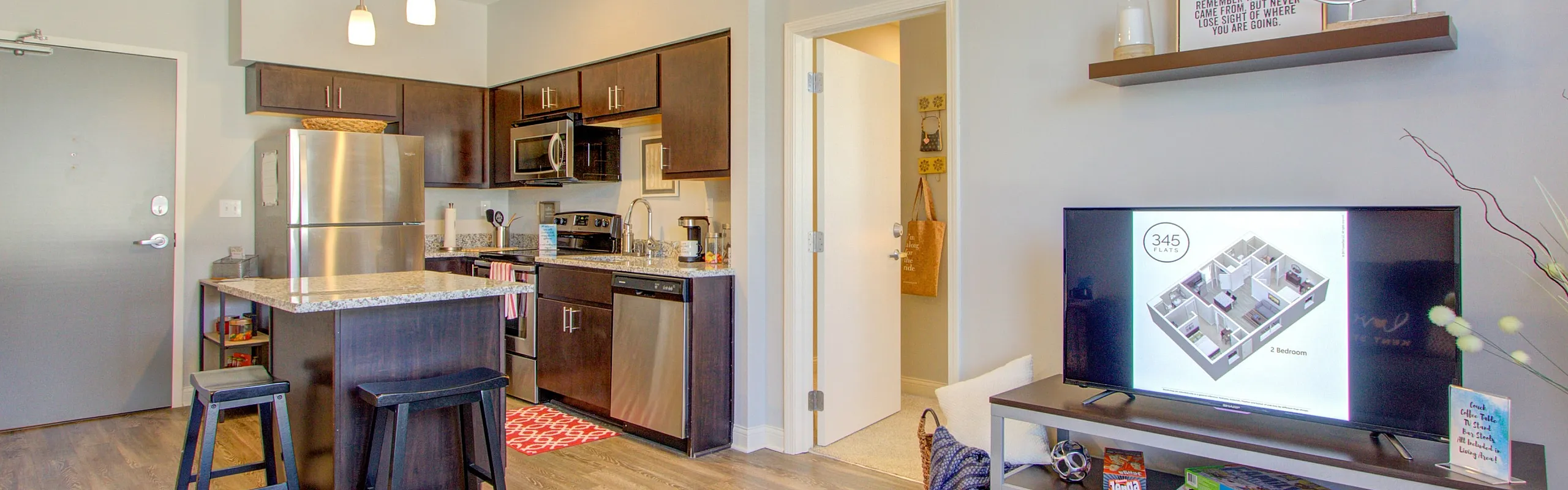 Modern apartment living area with stylish open kitchen features, elegant decor, and cozy ambiance.