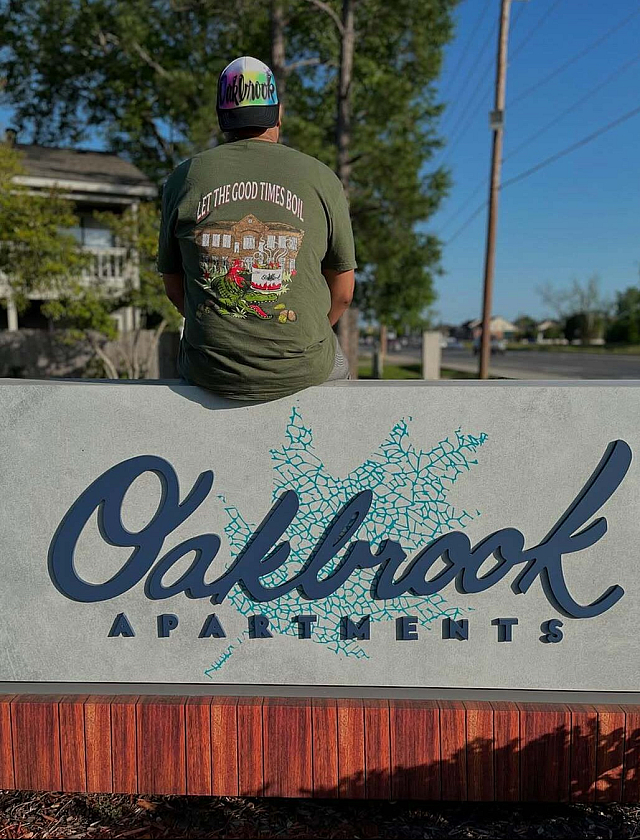 Inviting Oakbrook Apartments sign with a tranquil backdrop, highlighting a vibrant and welcoming community vibe.