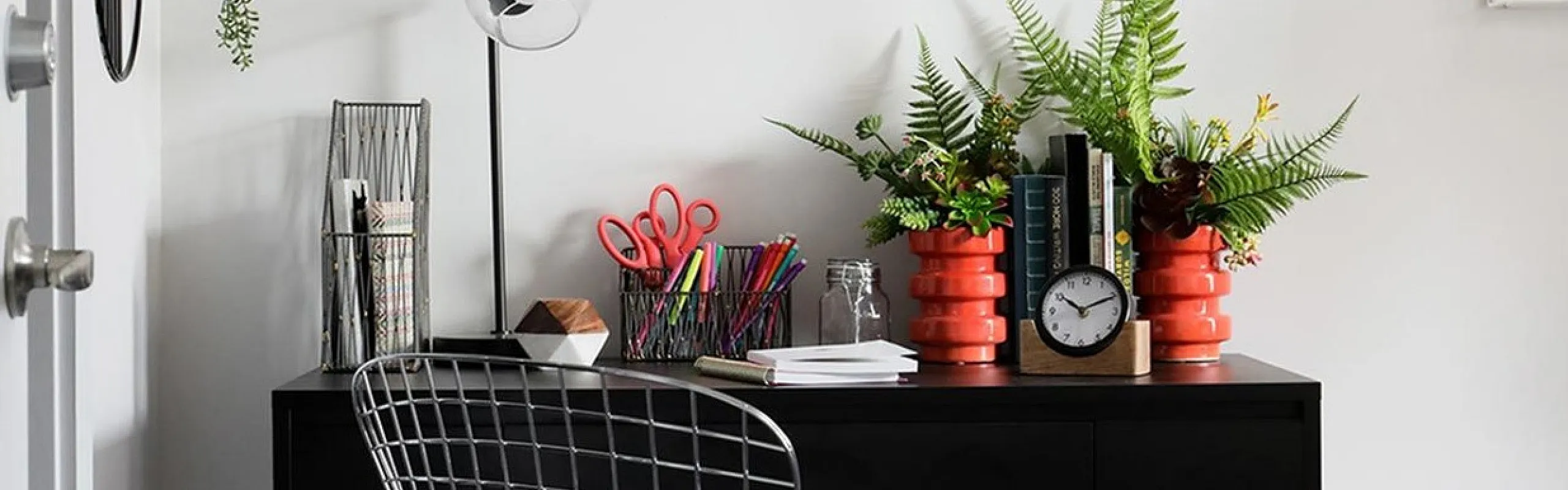 Chic home office setup with a modern desk, stylish chair, vibrant greenery, and a 'good vibes only' wall art, creating an inspiring workspace.