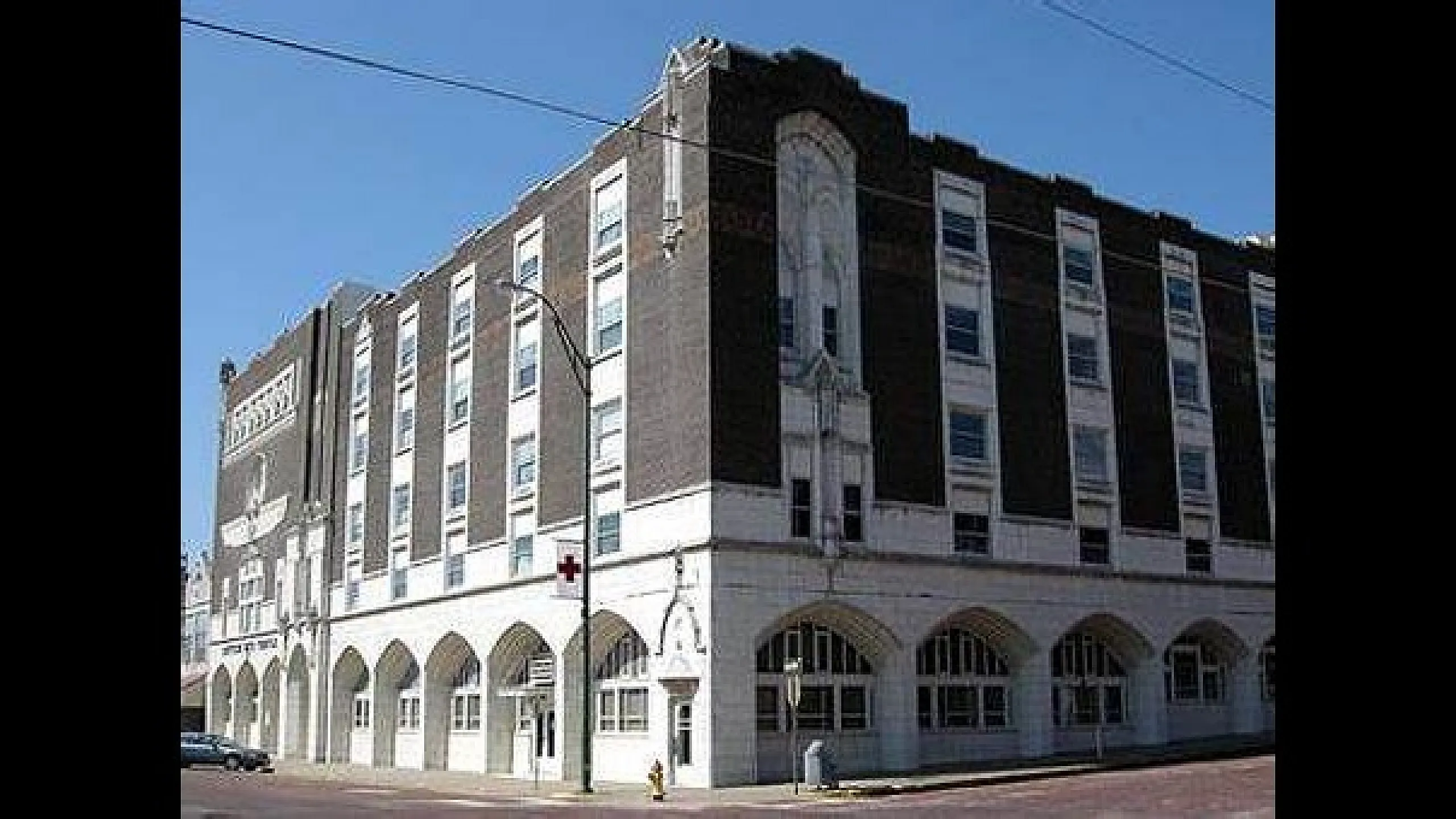 Charming historic apartment building with a classic architectural design featuring arched windows and detailed masonry.