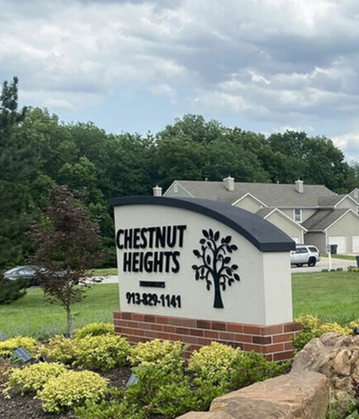 Welcoming entrance sign for Chestnut Heights amidst lush greenery and landscaped gardens.