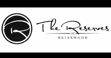 Elegant logo for The Reserves at Briarwood, featuring stylish script and graphic design.