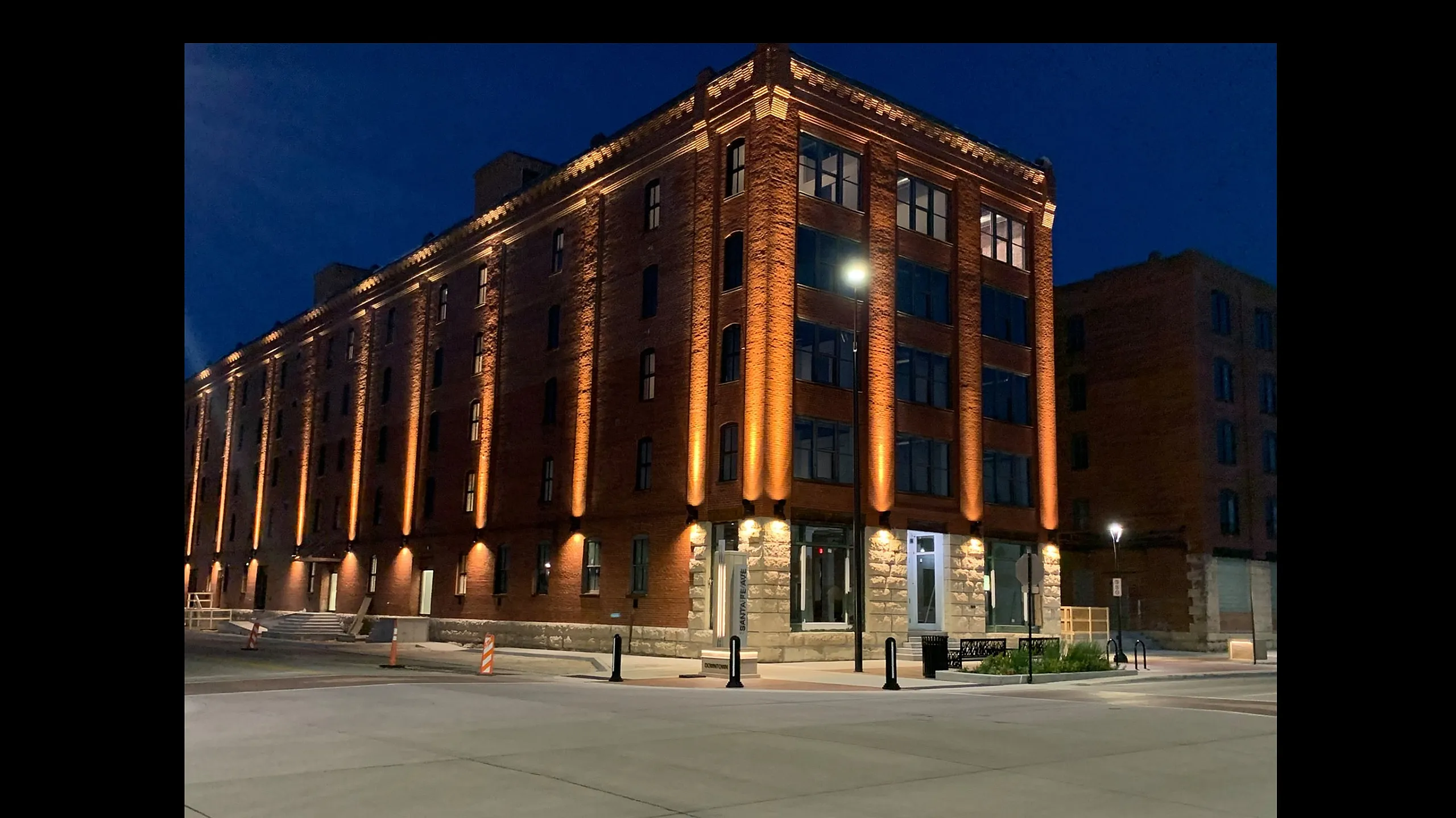Stunning brick building illuminated at night with modern architectural design and inviting entrance.