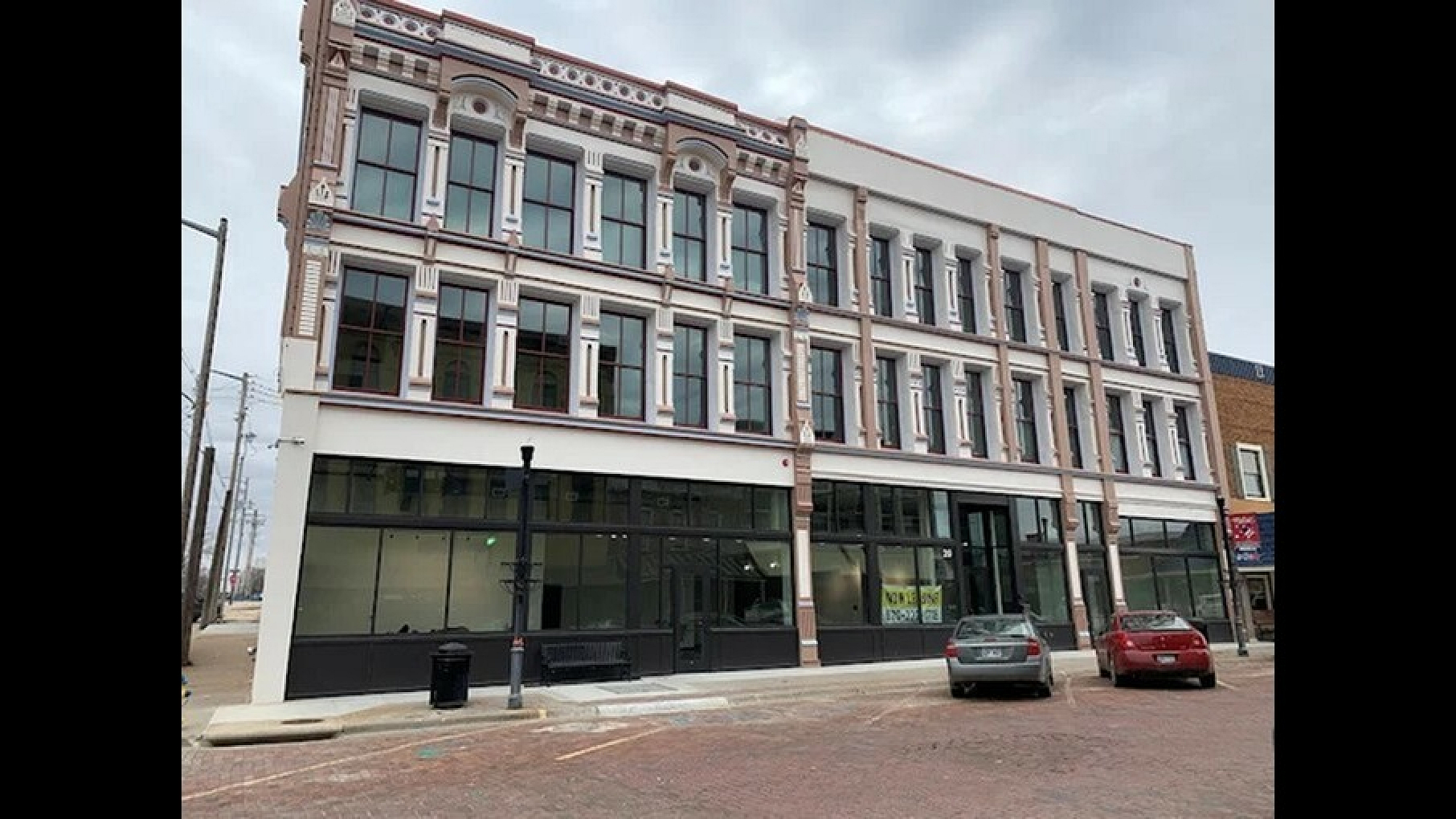 Charming historic building with elegant architectural details and large windows, offering potential for unique urban living spaces.