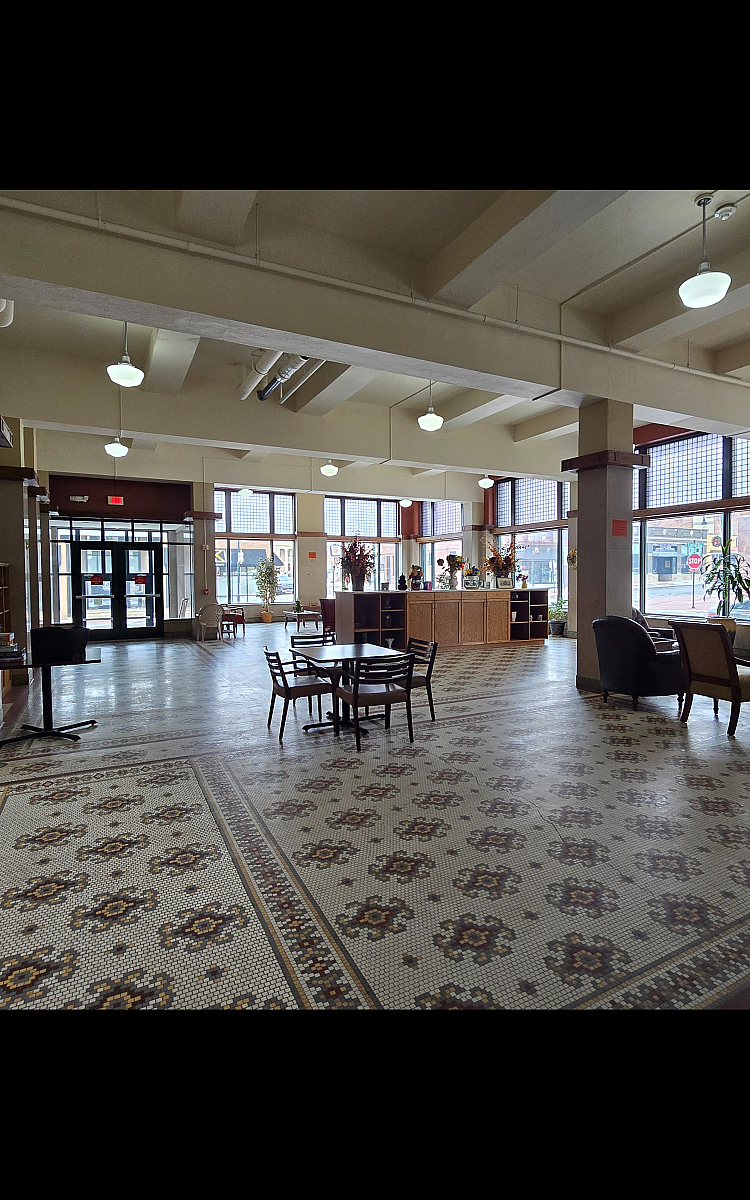 Elegant lobby with vintage tile flooring, ample natural light, and stylish seating areas, perfect for welcoming guests.