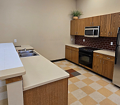 Community Kitchen with oven, microwave, and refrigerator.