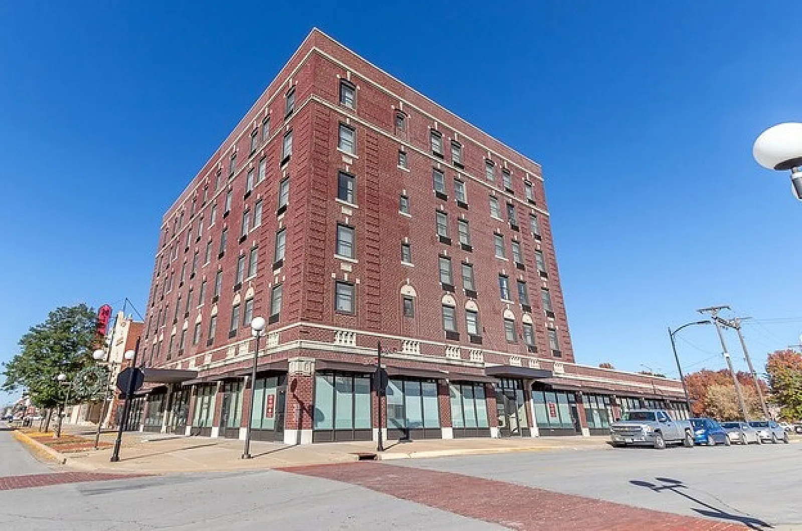 Charming historic brick building with large windows and classic architectural details, ideal for elegant city living.
