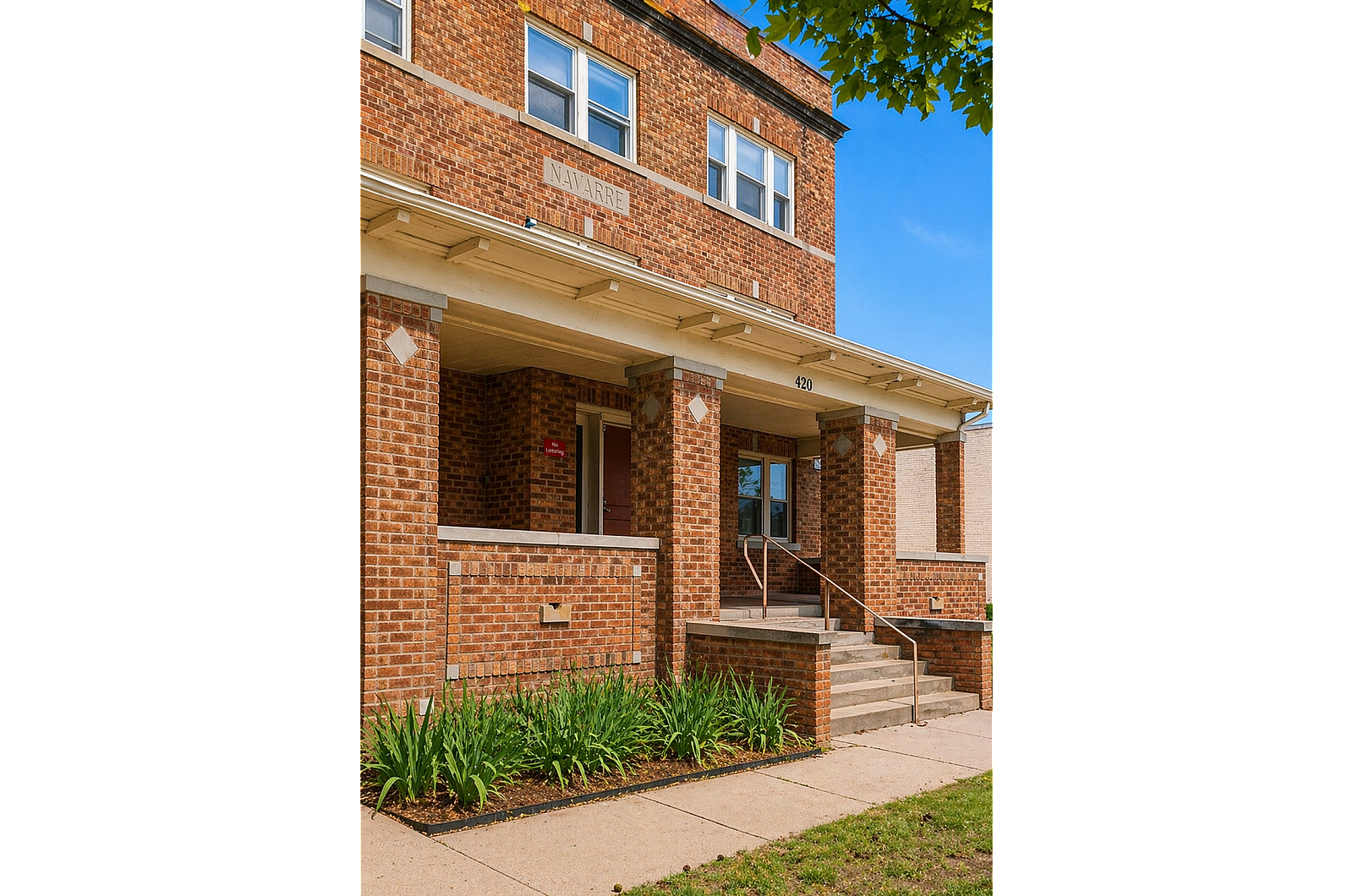 Charming brick apartment building with classic architecture and lush greenery, perfect for cozy urban living.