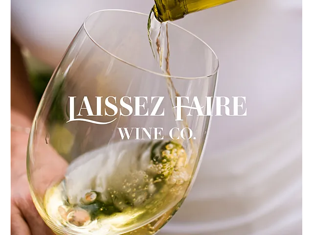 Elegant wine pouring into a glass with Laissez Faire Wine Co. branding, capturing sophistication and luxury.
