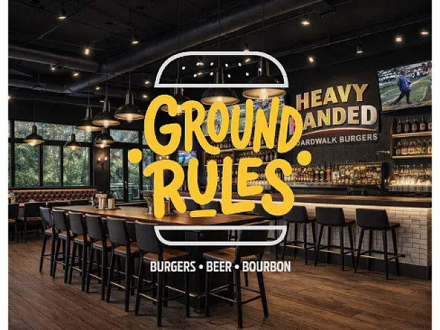 Inviting restaurant interior showcasing a stylish bar area with high seating, ambient lighting, and a vibrant atmosphere perfect for enjoying burgers, beer, and bourbon.