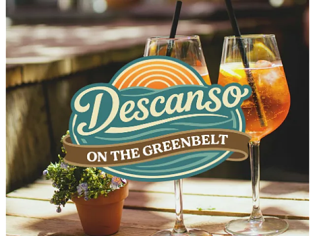 Inviting outdoor setting with two refreshing drinks adorned with orange slices at Descanso on the Greenbelt.