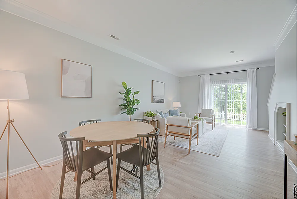 Bright, modern living and dining area with elegant decor, large windows, and tasteful furnishings offering a serene ambiance.