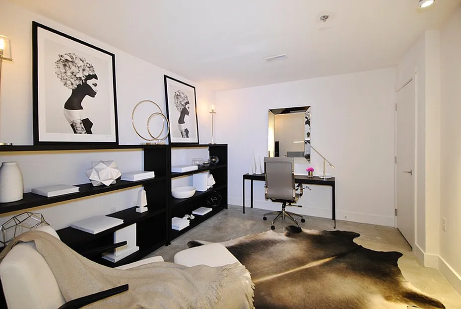 Chic home office space featuring modern artwork, stylish shelving, sleek desk, and elegant decor.