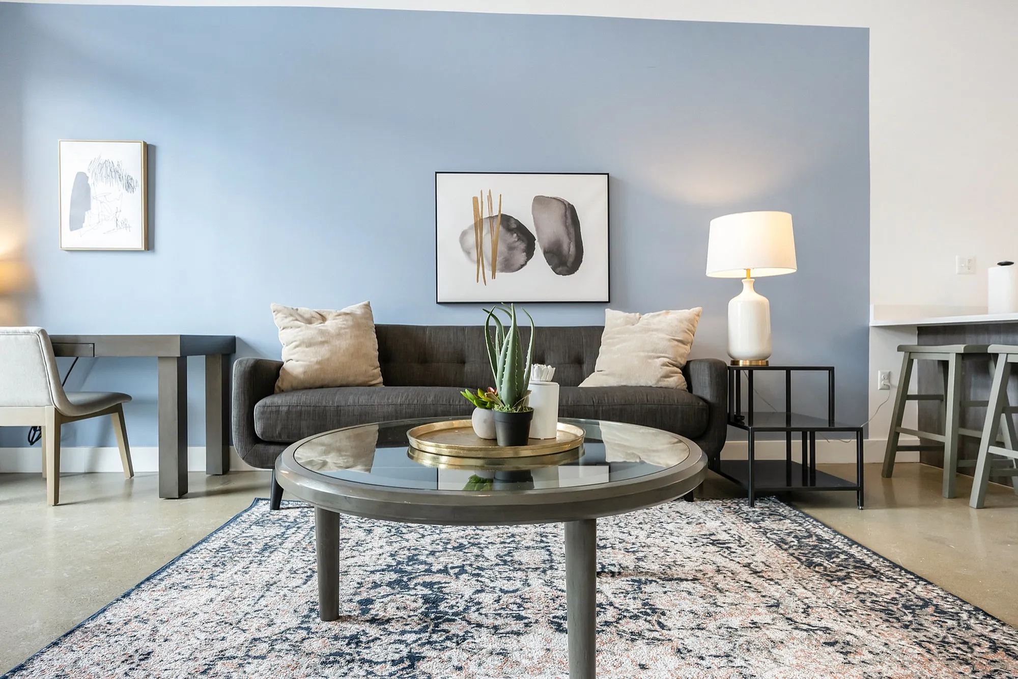 Chic living room with modern decor, featuring a comfortable sofa, stylish artwork, and a cozy ambiance enhanced by elegant lighting.