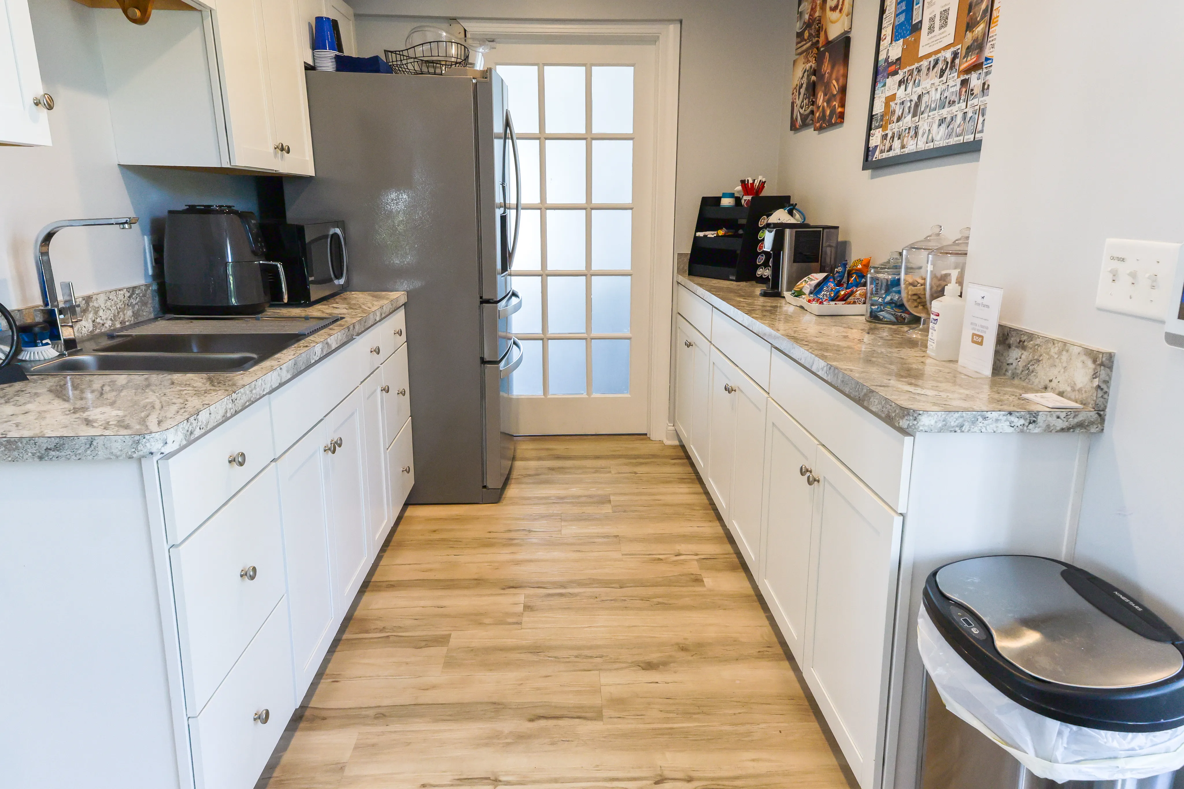 Inviting modern kitchen with sleek countertops, stylish white cabinets, and stainless steel appliances.