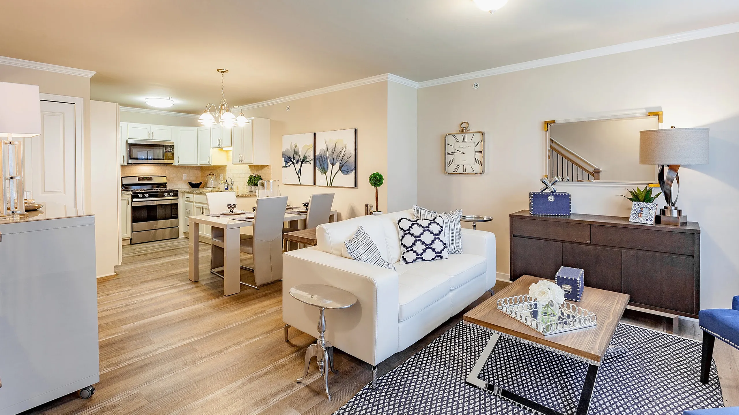 Chic open-concept living and dining area with elegant decor and modern kitchen.