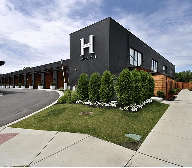 Modern luxury residences with sleek architecture, beautifully landscaped pathways, and vibrant greenery.