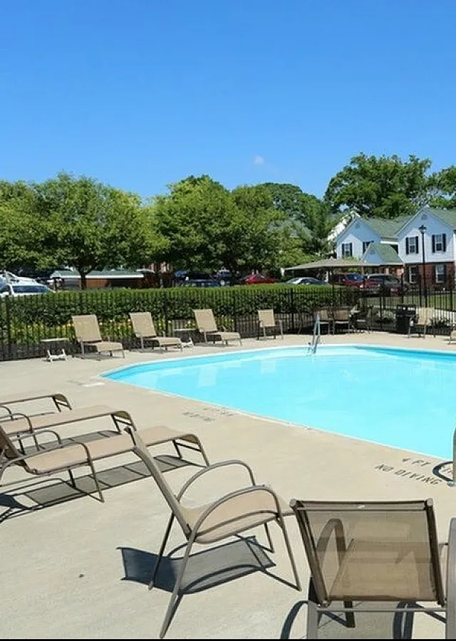 Inviting outdoor pool area with sun loungers and a charming garden backdrop, perfect for relaxation and leisure.