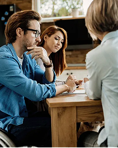Thoughtful professionals engaging in a collaborative meeting at a modern kitchen table, fostering creativity and connection.