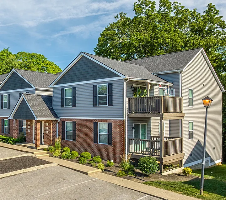 Charming duplex apartments with modern finishes, surrounded by lush greenery, featuring spacious balconies for outdoor relaxation.