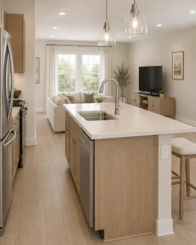 Bright and modern open-concept kitchen with sleek wooden cabinets, elegant island, and cozy living area featuring a large window and stylish decor.
