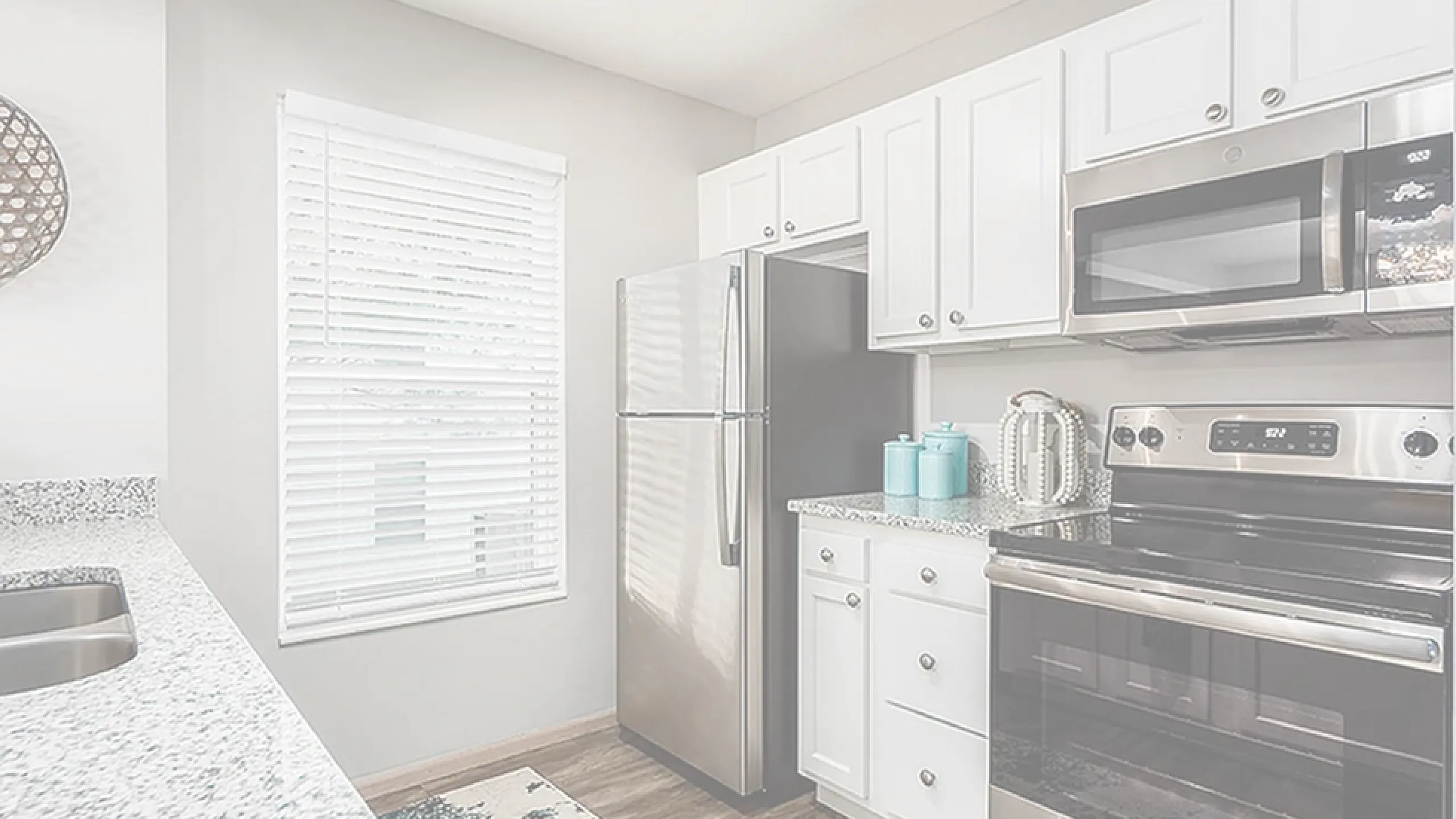 Modern kitchen with sleek stainless steel appliances, stylish white cabinets, and a granite countertop, perfect for culinary enthusiasts.