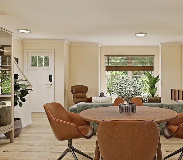 Inviting living space with elegant decor, featuring a round wooden dining table with leather chairs, large window with greenery view, and modern artwork on the wall.
