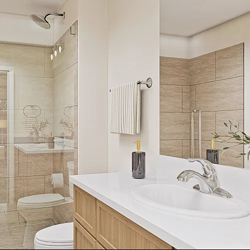 Elegant bathroom featuring a modern glass shower, sleek vanity with stylish sink, and tasteful decor, creating a serene spa-like ambiance.