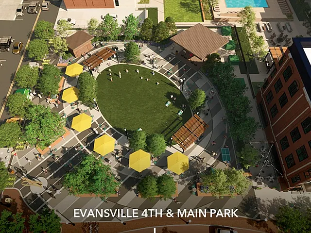 Aerial view of Evansville 4th & Main Park featuring a vibrant circular green space surrounded by lush trees, yellow parasols, and bustling walkways.