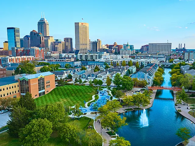 Downtown Indianapolis- Vibrant urban skyline with modern architecture, lush parks, and scenic waterways, offering an inviting blend of nature and city life.